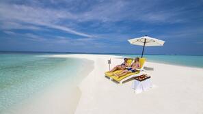 White sand, beach towels, windsurfing, surfing
