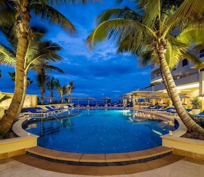 On the beach, white sand, beach cabanas, sun loungers
