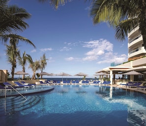 On the beach, white sand, beach cabanas, sun loungers