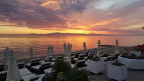 On the beach, sun-loungers, beach umbrellas, beach towels