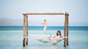 On the beach, white sand, beach umbrellas, beach towels
