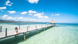 On the beach, white sand, beach umbrellas, beach towels