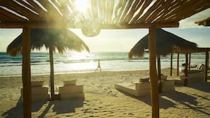 On the beach, white sand, sun-loungers, beach umbrellas