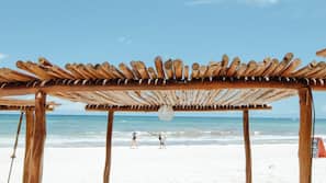 On the beach, white sand, sun-loungers, beach umbrellas