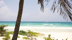 On the beach, white sand, sun-loungers, beach towels