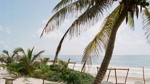 On the beach, white sand, sun-loungers, beach towels