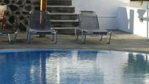 Seasonal outdoor pool, pool loungers