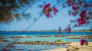 On the beach, white sand, sun-loungers, beach umbrellas
