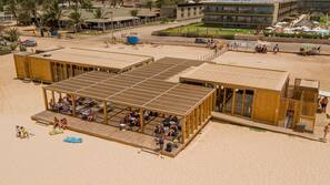 On the beach, white sand, sun loungers, beach towels
