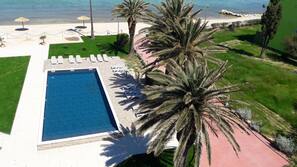 On the beach, sun-loungers, beach umbrellas, beach bar