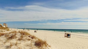 On the beach, white sand, sun loungers, beach umbrellas
