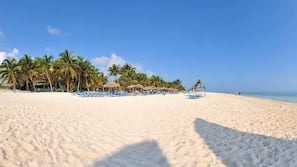 On the beach, sun loungers, beach towels, snorkeling
