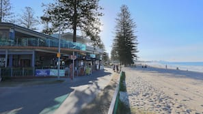 Beach nearby, white sand, beach towels