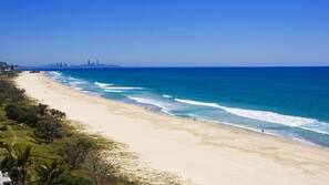 On the beach, white sand, beach umbrellas, beach towels