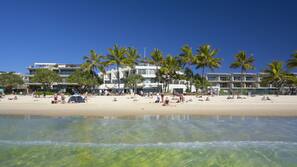 On the beach, white sand, beach umbrellas, beach towels