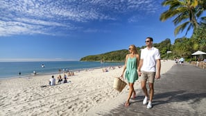 On the beach, white sand, beach umbrellas, beach towels