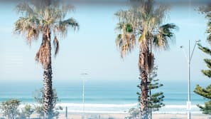Beach nearby, white sand, beach umbrellas, beach towels