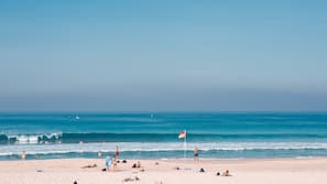 Beach nearby, white sand, beach umbrellas, beach towels