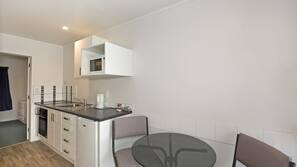 Fridge, microwave, coffee/tea maker, cookware/dishes/utensils