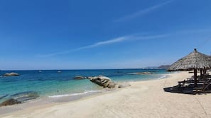 Private beach, white sand, sun loungers, beach umbrellas