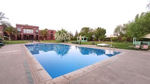Outdoor pool, open 9:00 AM to 8:00 PM, pool umbrellas, pool loungers