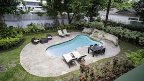 Outdoor pool, a waterfall pool, pool umbrellas, pool loungers
