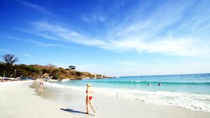 On the beach, white sand, beach umbrellas, beach towels