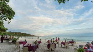 On the beach, white sand, beach umbrellas, beach towels
