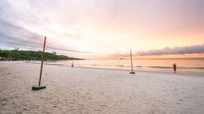 On the beach, white sand, beach umbrellas, beach towels