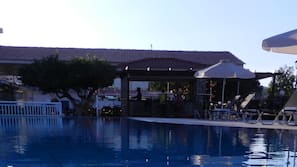 Seasonal outdoor pool, open 9:00 AM to 7:00 PM, pool umbrellas