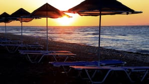 On the beach, sun-loungers, beach umbrellas, beach towels