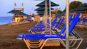 On the beach, sun-loungers, beach umbrellas, beach towels