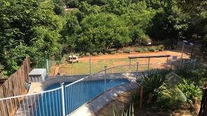Outdoor pool, open 9:00 AM to 7:00 PM, pool umbrellas