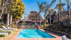Seasonal outdoor pool, open 7:00 AM to 7:00 PM, pool umbrellas