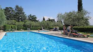 Piscine extérieure, parasols de plage, chaises longues