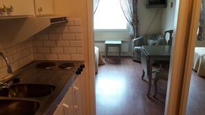 Microwave, hob, cookware/dishes/utensils, cleaning supplies