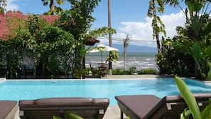 Outdoor pool, an infinity pool, pool umbrellas, sun loungers