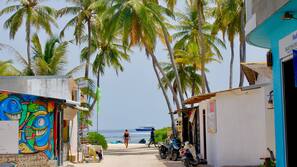 Beach nearby, white sand, beach umbrellas, beach towels