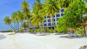 Beach nearby, white sand, beach umbrellas, beach towels