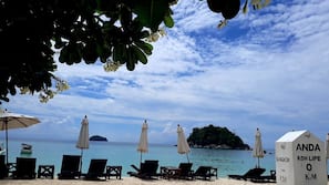 On the beach, sun-loungers, beach umbrellas, scuba diving