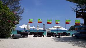 On the beach, sun-loungers, beach umbrellas, scuba diving