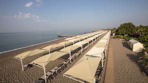 On the beach, sun-loungers, beach umbrellas, beach bar