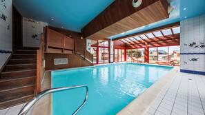 Indoor pool, pool umbrellas, pool loungers