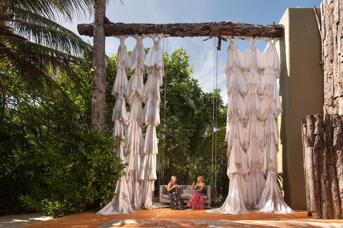two woman on a hanging couch at Casa Malca Tulum resort