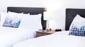 Premium bedding, desk, laptop workspace, blackout drapes