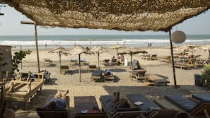 On the beach, beach umbrellas, beach towels, beach yoga