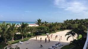 On the beach, white sand, beach umbrellas, beach towels