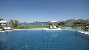 Seasonal outdoor pool, open 9:00 AM to 8:30 PM, pool umbrellas