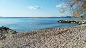 Beach nearby, white sand, beach umbrellas, beach towels