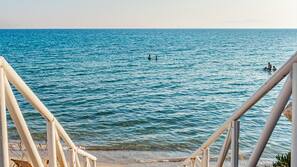 On the beach, white sand, sun-loungers, beach umbrellas